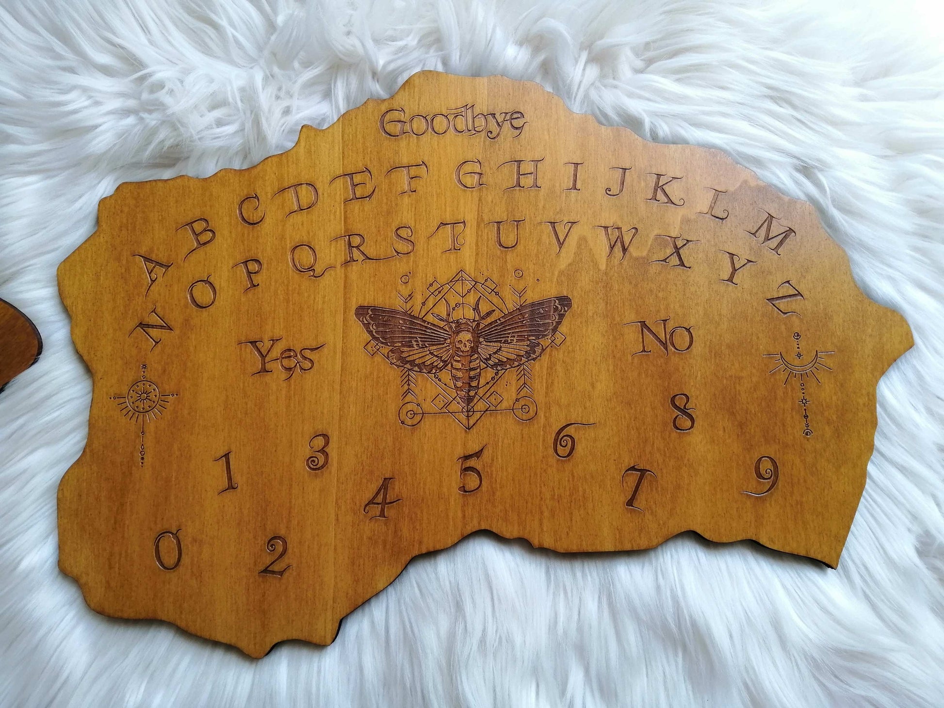 Planche Ouija 'Chrysalide' artisanale réalisée en bois de qualité supérieure, grand format (49cm x 33cm). Chaque planche est fabriquée à la main avec un soin particulier, alliant l'art mystique et l'artisanat traditionnel. Idéale pour les séances de divination, le spiritisme ou comme décoration ésotérique dans votre maison. Personnalisation possible avant l'achat. Un objet unique pour les passionnés d'arts occultes, fabriqué en France